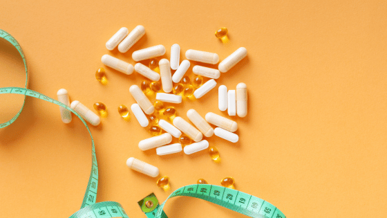 Weight loss supplements and a measuring tape